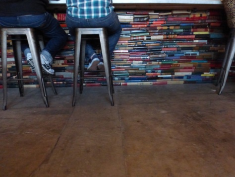 Books stacked up under the bar.